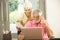 Worried Senior Couple Using Laptop At Home