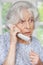 Worried Senior Woman Answering Telephone At Home