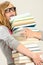 Worried student girl carry stack of books