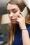 Worried Teenage Girl Making Call On Mobile Phone