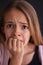 Worried teenager girl bite her nails - close up portrait