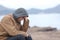 Worried teenager guy on the beach in winter