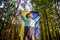 Worried teenager patriot wear blue yellow Ukrainian flag on his shoulders. Spring nature background. Ukraine national symbol.