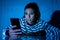 Worried unhappy young woman suffering from cyberbullying and harassment online by mobile phone