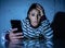 Worried unhappy young woman suffering from cyberbullying and harassment online by mobile phone