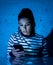 Worried unhappy young woman suffering from cyberbullying and harassment online by mobile phone