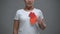 Worried woman holding paper heart sign, prevention of stroke and heart attack