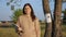 Worried woman holds paper stack near missing cat poster