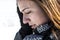 Worried woman in snow covered fields landscape