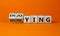 Worring or enjoying concept. Turned wooden cubes and changed word `worring` to `enjoying` on a beautiful orange background. Co