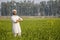 worry less indian farmer standing hand folded in his healthy wheat field