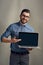 Wouldnt you like to take business even further than before. Studio portrait of a young man holding a laptop against a