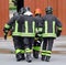 WOUNDED carried by firemen on a stretcher