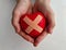 Wounded heart with a band aid in children hands and pediatric cardiology