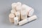 Woven elastic medical bandages rolls different sizes on gray surface