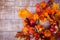 Woven wreath decorated orange leaves, autumn vegetab