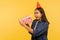 Wow, amazing present! Portrait of shocked excited girl in denim shirt and funny cone hat opening birthday gift