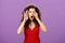 Wow awesome take look. Amazed and surprise curious caucasian woman with curly hair in red stylish dress open mouth from