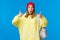 Wow really cool, good job. Impressed good-looking blond young female student in red beanie and yellow hoodie, carry
