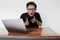 Wow face of Young Asian man shocked what he see in the laptop when working  grey background