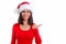 Wow fantastic tell more. Intrigued fascinated young woman is smiling in red christmas Santa hat. Emotional girl stands