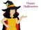 Wow !Halloween. Happy girl in a hat and a witch costume blowing