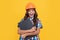 wow. surprised girl in protective hard hat. amazed child in helmet hold project.