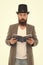 Wow. Surprised library reader. Hipster read library book. Bearded man wear top hat in casual style. Borrowing literature