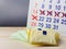 Wrap several pieces of sanitary napkins on a wooden table, the calendar is blurred on the back with a red cross on some date