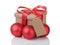 Wraped gift box with red bow, christmas balls and tag