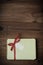 Wrapped Gift Package with Red Raffia Bow on Wood Planking - Retr