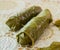 Wrapped meat in green vine leaves a decorated board