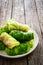 Wrapped minced meat in cabbage leaves - polish dish golabki on wooden table