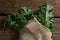 Wrapped mustard greens on wooden table