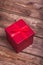 Wrapped red gift box on wooden background can use on valentine day mother day or celebrate love day.