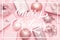 Wrapped xmas boxes, christmas ornaments and baubles. Pink christmas gifts isolated on pastel pink background.