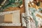 Wrapping christmas gift. Stylish festive wrapping paper, craft gift box, scissors, ribbons and modern decorations on wooden table