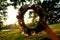 Wreath of different flowers on a background of blue sky. flowers wreath in women hands in the evening sunset