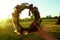 Wreath of different flowers on a background of blue sky. flowers wreath in women hands in the evening sunset