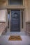 Wreath and doormat on the front door with sidelights and transom window