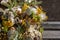 Wreath of dried twigs and flowers on a wooden background. Natural decoration. Celebration concept. Easter wreath. Willow round