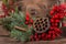 Wreath with lotus flower and red berries. Christmas winter frame on dark wooden background. Red elements