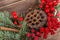 Wreath with lotus flower and red berries. Christmas winter frame on dark wooden background. Red elements