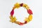 The wreath is made of willow twigs and colorful leaves of maple, hawthorn and parthenocissus on a white background.