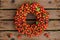 Wreath of rosehips on a wooden background