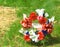 Wreath wtih Red, White and Blue flowers in military cemetery