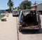 A wreck of a car in a street in the tropical Tonga