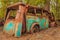 Wreck of a colorful rusted old transport bus