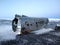 The wreckage of an abandoned DC 3 plane on a black ocean beach in Iceland. Popular attractions in Iceland