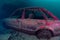 Wreckage of an old, abandoned car underwater in a UK quarry